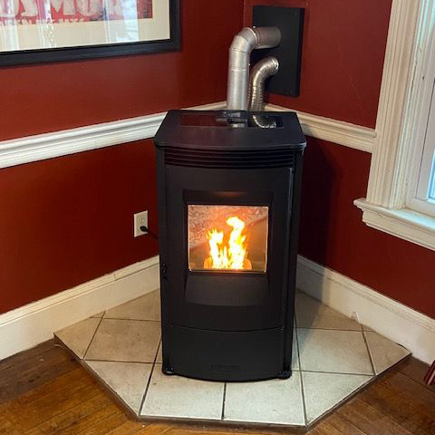 Photo of a woodstove on a brick hearth